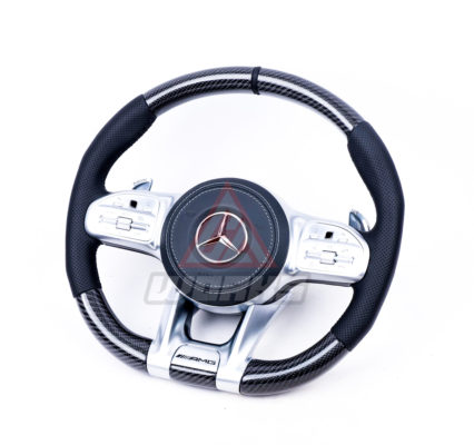 A 2019+ generation retrofit amg steering wheel, customized in gloss black carbon fiber, black perforated leather side grips, black nappa leather airbag and satin silver equipment.